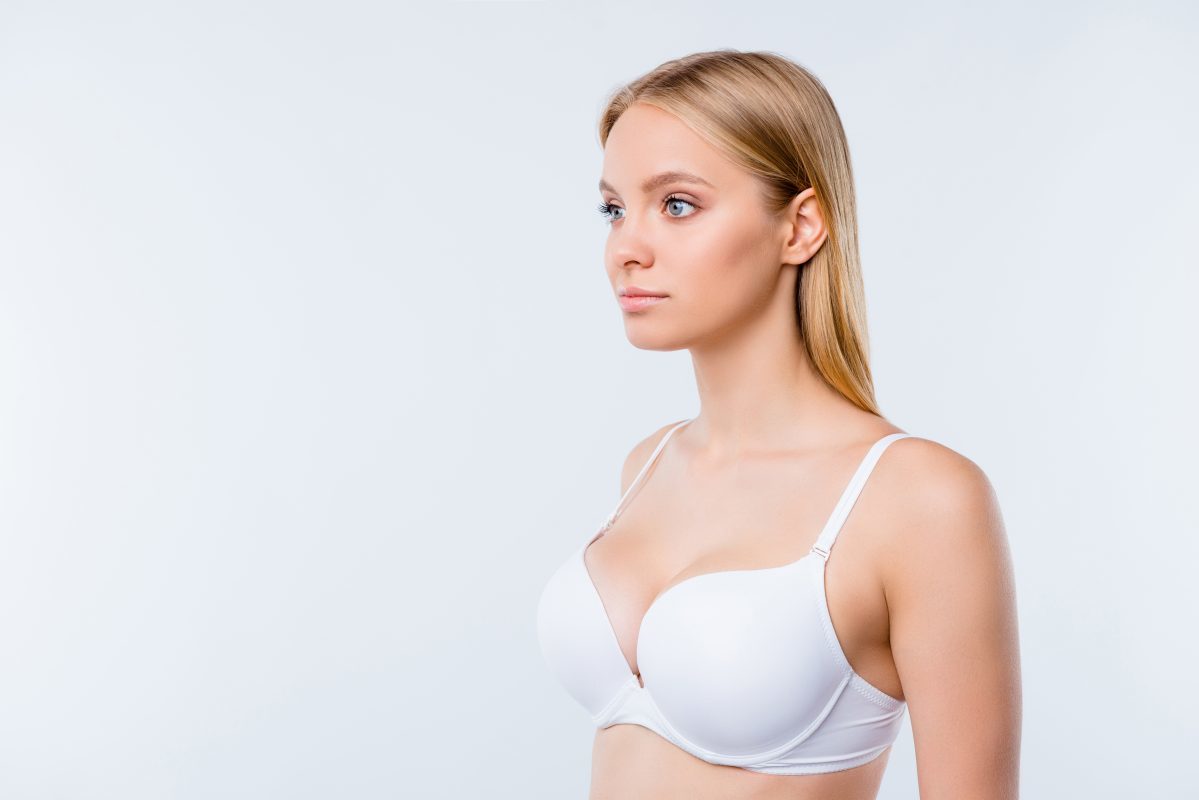 Healthy successful lifestyle concept. Portrait of nice cute lovely winsome attractive minded blonde girl wearing bra isolated over light gray background